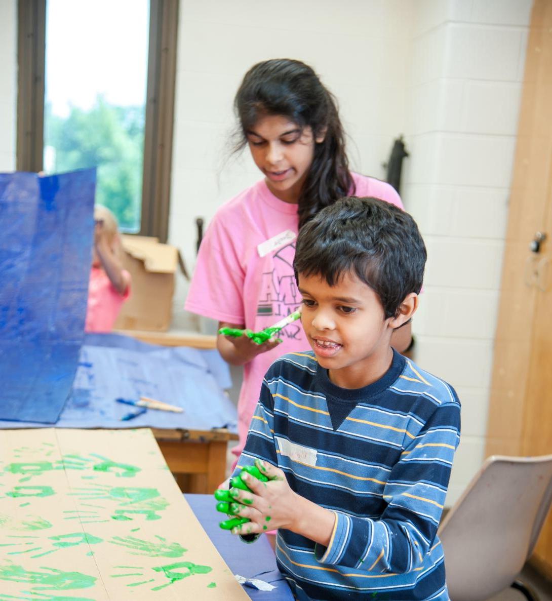 Youth working with clay at art camp